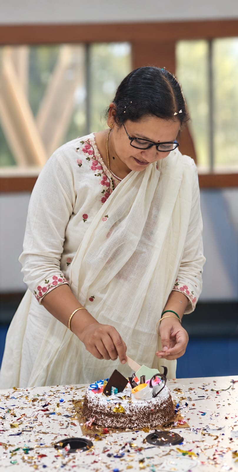 Two pairs of hands planting a young sapling together